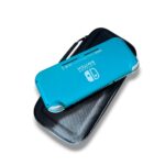 Turquoise Nintendo Switch Lite resting on an open black carrying case, viewed from above.