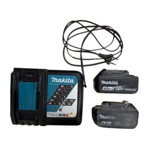 Makita battery charger with two 18V lithium-ion batteries and a tangled power cord beside it