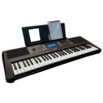 Yamaha digital keyboard with 61 keys, built-in speakers, and sheet music on the music rest plate