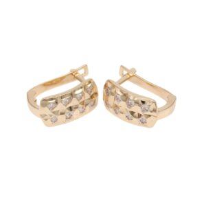 Gold-tone hoop earrings with a geometric, pavé-set row of small clear stones on the front surface