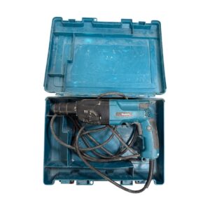 Blue Makita corded drill in an open blue plastic carrying case, with tangled power cord inside the box