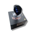 Smartwatch with round black face displayed on a transparent stand atop a black retail box, Huawei logo visible on the box edge:** product photo