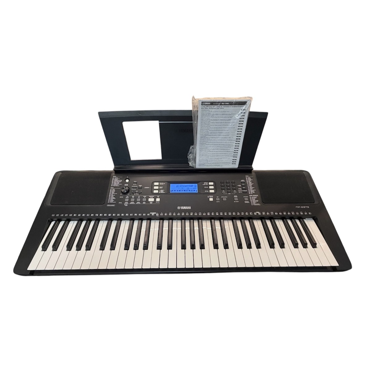 18fe6a32c8ea5c0876d8c2582f21db1ajpg - Mezola OÜ Yamaha electronic keyboard with built-in speakers, control panel, and sheet-music stand with manual on top of the stand