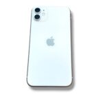 Back of a white iPhone showing the dual-camera module in the top-left corner and Apple logo