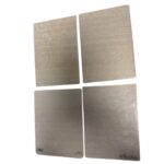 Set of four metal embossing folders with swirling floral patterns for paper crafting
