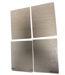 Set of four metal embossing folders with swirling floral patterns for paper crafting