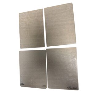 Set of four metal embossing folders with swirling floral patterns for paper crafting