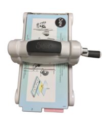Sizzix die-cutting machine with handle used to cut shapes from paper.