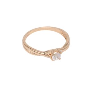Rose gold engagement ring with a single round diamond in a twisted band setting on a white background