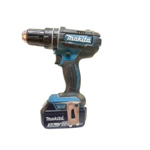 Cordless Makita drill with a teal and black body and a copper drill bit visible at the chuck