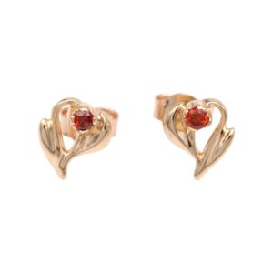 Gold heart-shaped earrings with small red gemstone at center, set in a delicate open-heart design