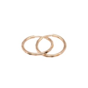 Three rose‑gold rings with faceted bands overlapping each other on a white background show a jewelry arrangement.