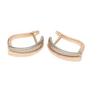 Two-tone curved hoop earrings in rose gold with a silver ribbed central bar.