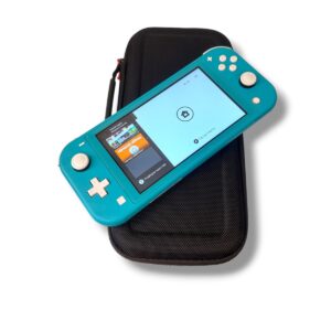 Turquoise Nintendo Switch Lite resting on a black protective carrying case.