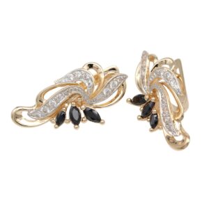 Gold-tone earrings with a swirling leaf design studded with small diamonds and black gemstone accents at the base, for a luxurious look.