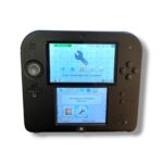 Black Nintendo 3DS handheld console with two screens open, displaying system settings in Russian on both displays against a white background.