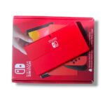 Red Nintendo Switch packaging with a red handheld console resting on top of the box