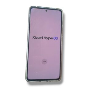 Phone screen shows Xiaomi HyperOS logo on a pink gradient background with a circular proceed button.
