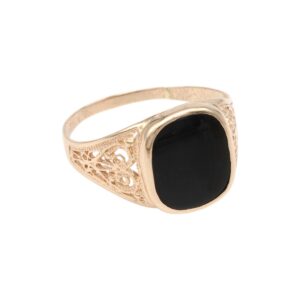 Gold-toned ring with a large black oval cabochon and intricate filigree sides.