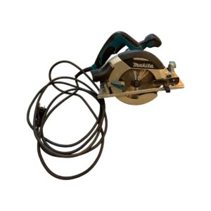 Makita circular saw with cord wrapped around handle, silver blade exposed and orange shoe attachment visible