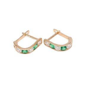 Gold-tone hoop earrings with alternating green and clear crystals along the front curve