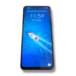 Lock screen on a smartphone showing time 11:59 and date, with a speedboat moving through blue water wallpaper