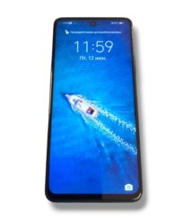 Lock screen on a smartphone showing time 11:59 and date, with a speedboat moving through blue water wallpaper