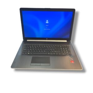 Open HP laptop with blue login screen displayed on the display, keyboard visible, placed on a white background