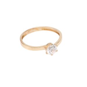 Gold solitaire engagement ring with a round diamond in a four-prong setting.