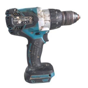 Cordless power drill with teal and black body, adjustable chuck, and a worn grip handle.