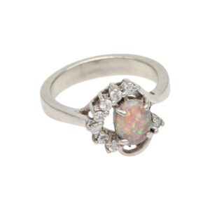 Silver ring with an oval opal center surrounded by small diamonds.