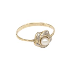 Gold ring with a central pearl and diamond-accented setting in a floral design