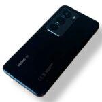 Rear view of a dark blue Redmi smartphone with a triple-camera module in the top-left corner of the back panel.