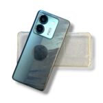 Blue smartphone with two-camera module and a circular pop socket on its back, displayed with a clear case behind.
