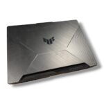 Closed silver gaming laptop with a brushed metal finish and angular panel design, logo on the lid.