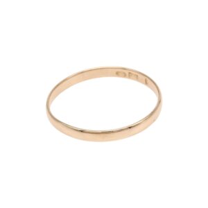 Gold wedding band on a white background, simple and polished