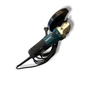 Corded angle grinder with a worn guard and black power cord (Makita brand).