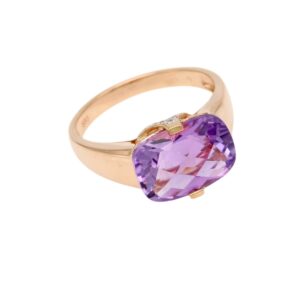 Rose-gold ring featuring a heart-shaped purple gemstone (amethyst) set in a prong setting on a smooth band]