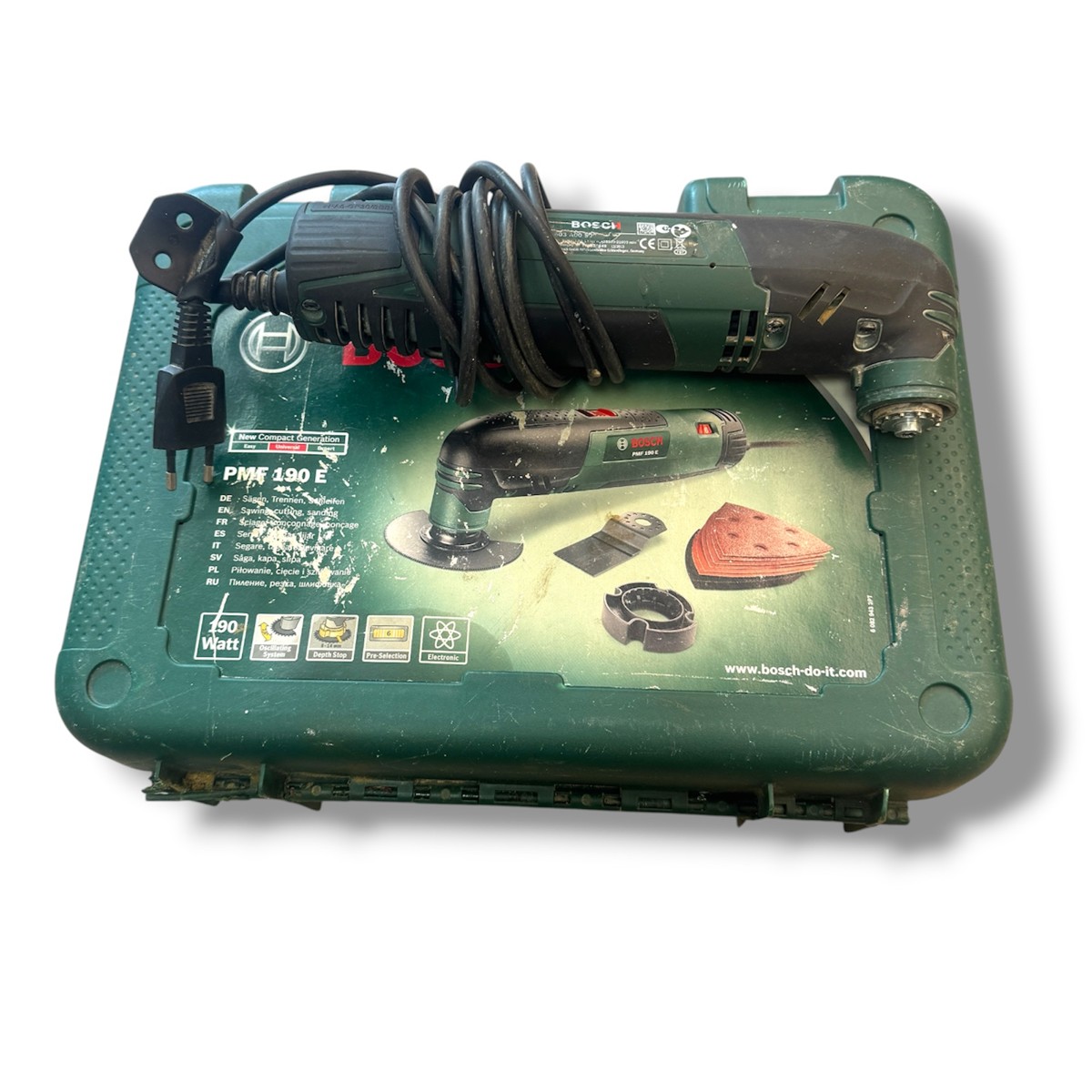 5b721c8f2df5d9213dc932de45ba113djpg - Mezola OÜ Bosch PMF 180 E oscillating multi-tool with cord wrapped on a green Bosch carrying case showing accessories on the box image