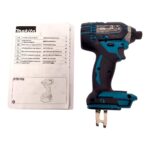 Makita cordless impact driver with instruction manual beside it, showing a teal and black drill and a printed manual