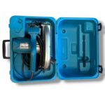 Open blue plastic carrying case with a Makita circular saw and coiled power cord inside