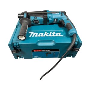 Makita HR2630J hammer drill placed on its teal carrying case with cord extending from the tool