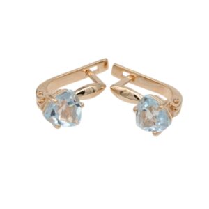 Gold-tone clip-on earrings with pale blue faceted gemstones in prong settings.