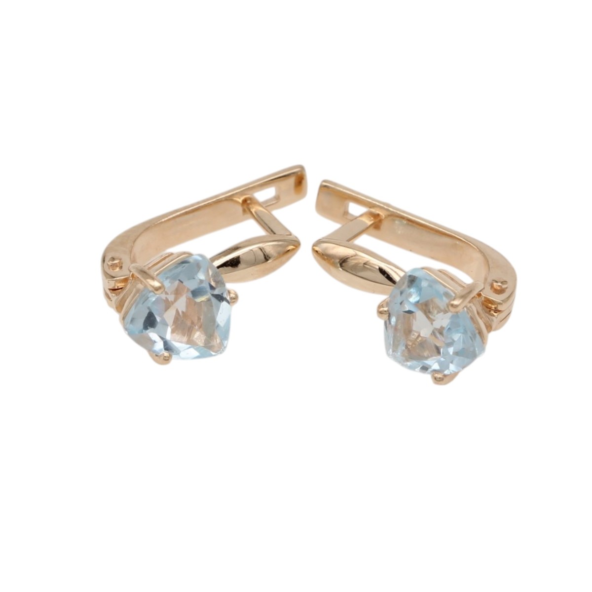 a498ae54e8bd3b37cb975fe789d22f24jpg - Mezola OÜ Gold-tone clip-on earrings with pale blue faceted gemstones in prong settings.