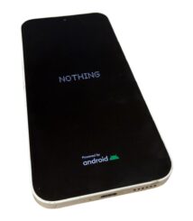 Smartphone with a black screen showing the word NOTHING and an Android logo at the bottom.