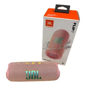 Pink JBL Flip 7 portable Bluetooth speaker with gold mesh, shown in front of its white and orange packaging box.
