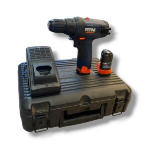 Cordless drill with orange accents resting on a black plastic carrying case next to a charger and spare battery.