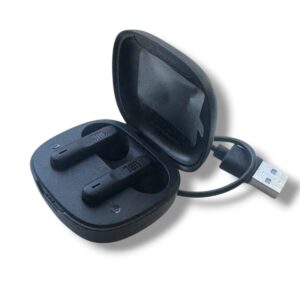 Black wireless earbuds nestled in an open charging case with a USB-A plug nearby, ready to charge and pair.