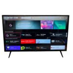 LG Content Store homepage on a wall-mounted smart TV with rows of app tiles like OTT+, Spotify, and YouTube.