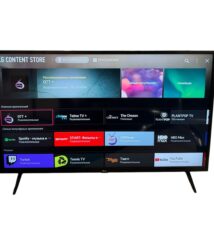 LG Content Store homepage on a wall-mounted smart TV with rows of app tiles like OTT+, Spotify, and YouTube.